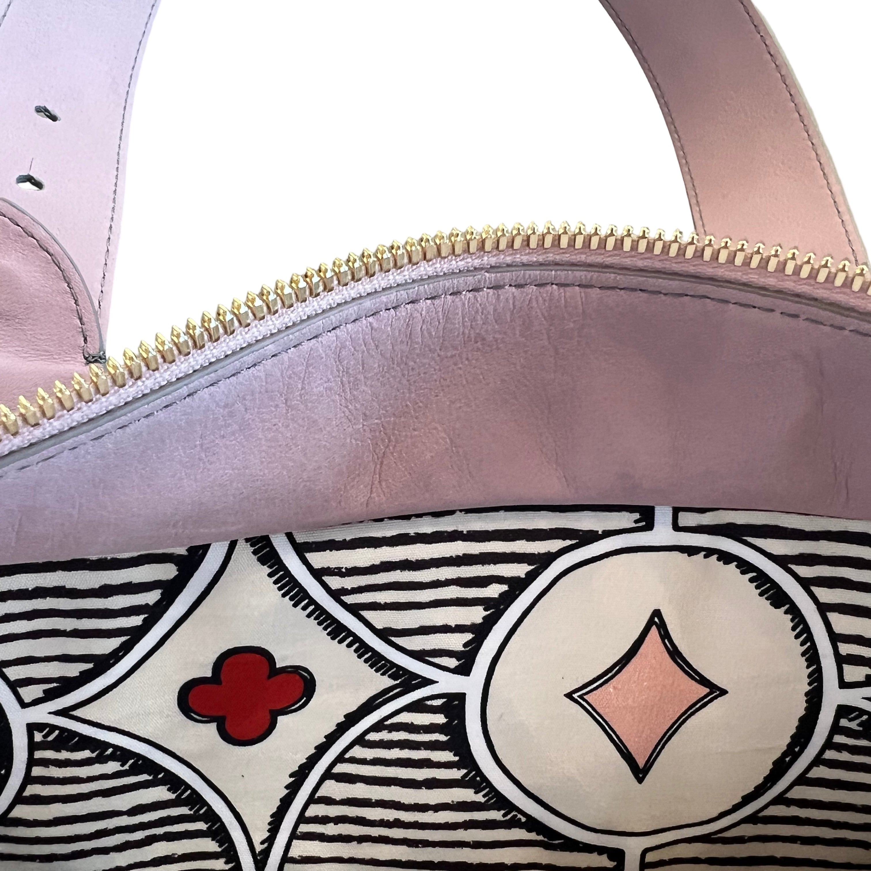 Close-up of a handbag with decorative patterns and a zipper.
